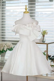 White dress on a mannequin with a blurred indoor background