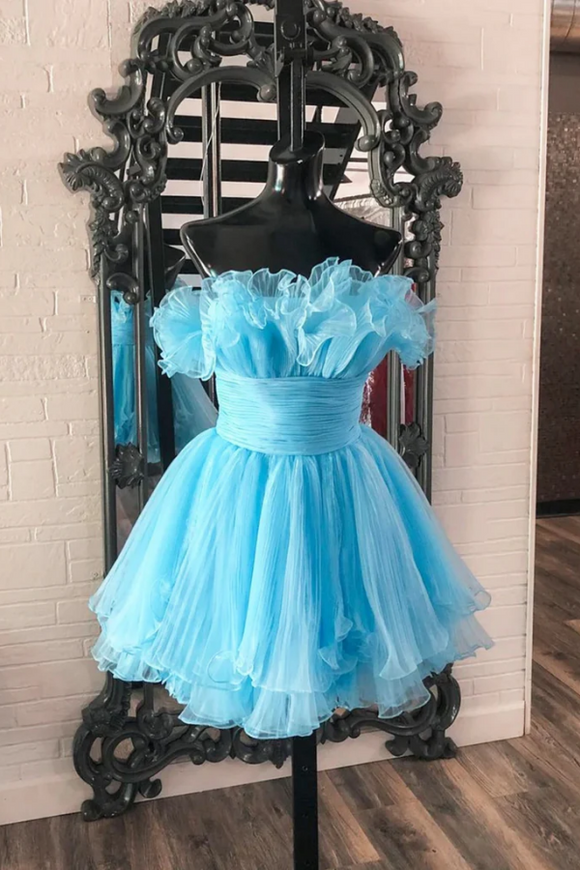 Light blue dress on a mannequin in front of a decorative mirror.