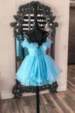 Light blue dress on a mannequin in front of an ornate mirror with a brick wall background.