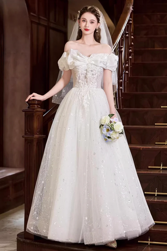 Woman in a white wedding dress standing on a staircase