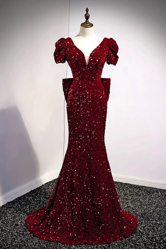 Red sequin evening gown on a mannequin against a plain background