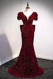 Red sequin evening gown on a mannequin against a plain background