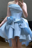 Light blue strapless dress with a large bow detail on a neutral background