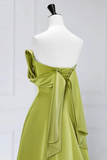 Green one-shoulder dress on a mannequin against a white background