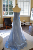 Blue evening gown on a mannequin in a room with a window and chair.