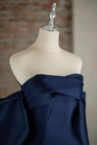 Navy blue fabric draped over a mannequin against a neutral background