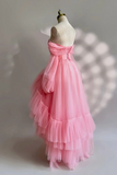 Pink evening gown on a mannequin against a neutral background