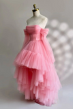 Pink tiered dress on a mannequin against a neutral background