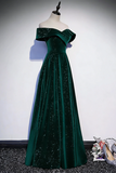 Green off-shoulder evening gown on a mannequin against a white wall.