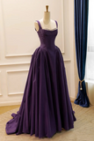 Purple evening gown on a mannequin against a neutral background