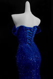 Blue sequin dress on a mannequin against a black background