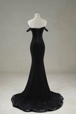Black evening gown on a mannequin against a plain background