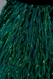Close-up of green tinsel with a dark background