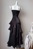 Black evening gown on a mannequin against a neutral background