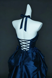 Navy blue dress on a mannequin against a dark background