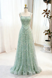 Green evening gown on a mannequin against a white curtain background