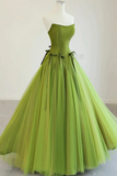 Green evening gown on a mannequin against a white background