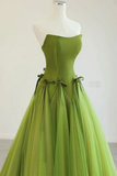 Green evening gown on a mannequin against a white background