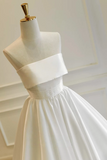 White dress on a mannequin against a neutral background
