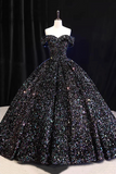 Black sequin evening gown on a mannequin against a dark background
