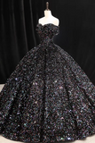 Black sequin evening gown on a mannequin against a dark background