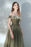 Woman wearing an off-shoulder green dress with ruffled details against a light background