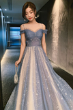 Woman in a blue evening gown standing in a hallway.