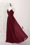 Burgundy evening gown on a mannequin against a white background