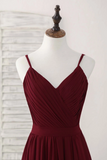 Burgundy dress on a mannequin against a white background