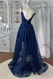 Navy blue lace evening gown on a mannequin in a decorative setting with chandelier and curtains.
