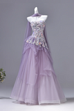 Lavender evening gown with floral embellishments on a mannequin against a gray background