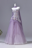 Purple evening gown with floral embellishments on a mannequin against a gray background