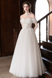 Woman in a white wedding dress standing on a staircase