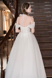 Woman in a white wedding dress standing on a staircase