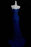 Blue evening gown on a mannequin against a black background