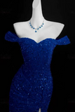 Blue dress on a mannequin with a black background