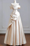 White wedding dress on a mannequin against a plain background