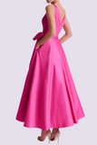 Pink evening gown with a bow detail on a light purple background