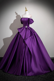 Purple ball gown on a mannequin against a plain background