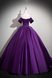Purple ball gown on a mannequin against a gray background