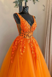 Orange evening gown with floral details on a mannequin against a neutral background.