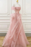 Pink evening gown on a mannequin against a white wall.