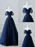 Navy blue evening gown on a mannequin with close-up details against a light gray background.