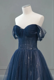 Navy blue evening gown on a mannequin against a gray background