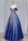 Blue sparkly evening gown on a mannequin against a white curtain background