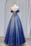 Blue evening gown on a mannequin against a white curtain background