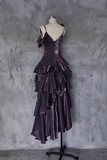 Purple ruffled dress on a mannequin against a textured gray wall