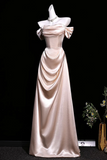 Elegant satin gown with a large bow on a black background