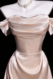 Beige satin dress on a mannequin with a black background