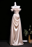 Beige evening gown on a mannequin against a black background
